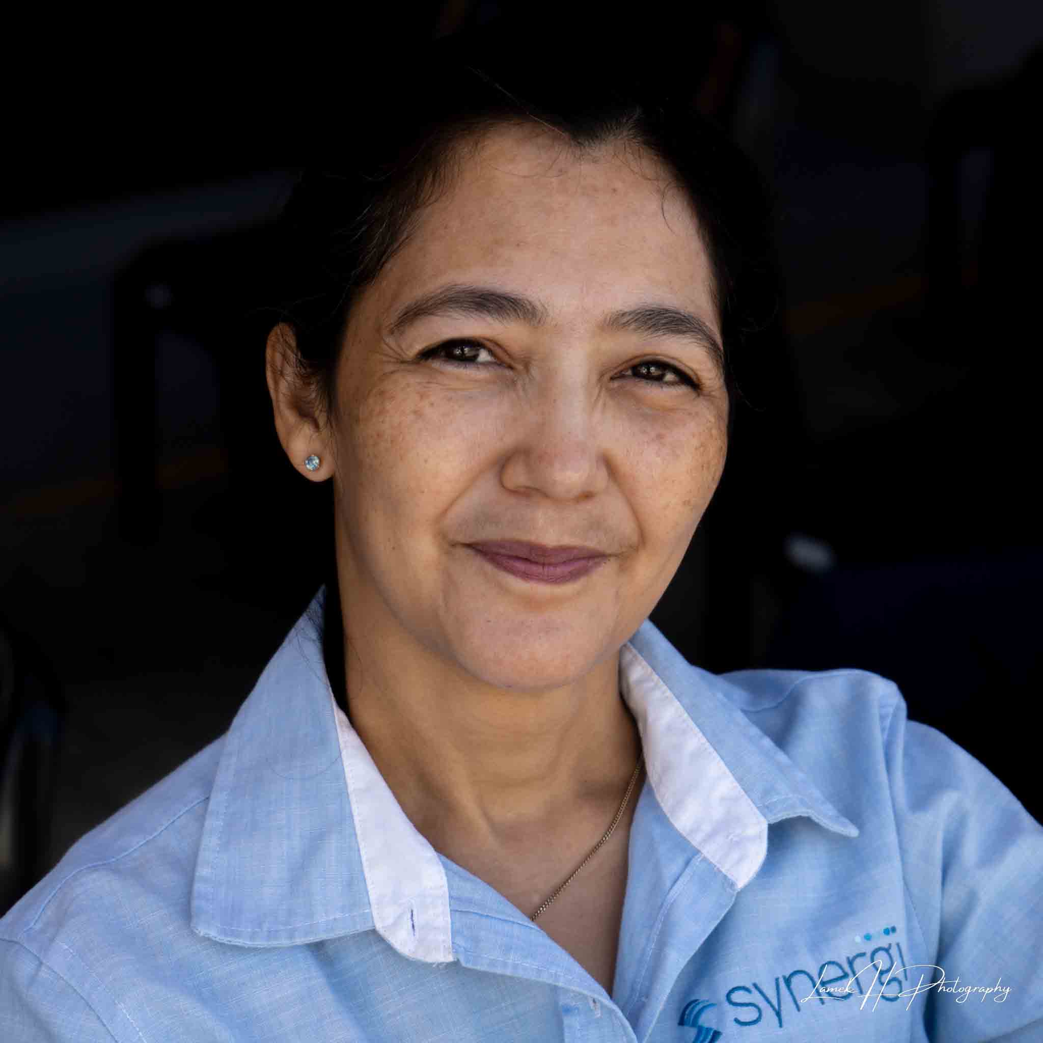 Candid portrait of a smiling woman against a blurred background